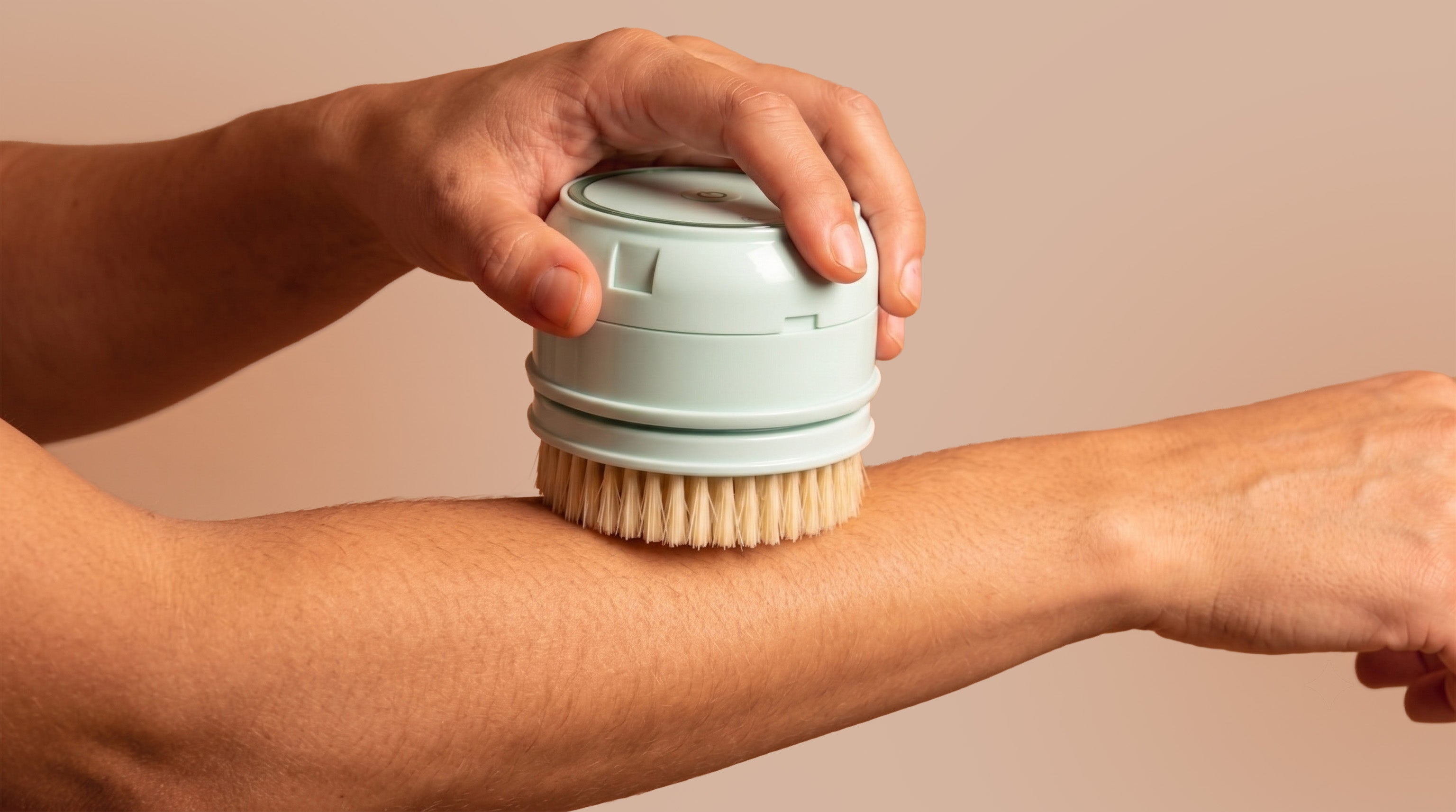 rollerstone electric dry body brush used on arm for dry brushing routine