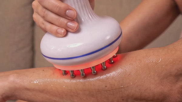 woman using a rollerstone lymphatic drainage massager on her arm as part of an everyday self-care ritual