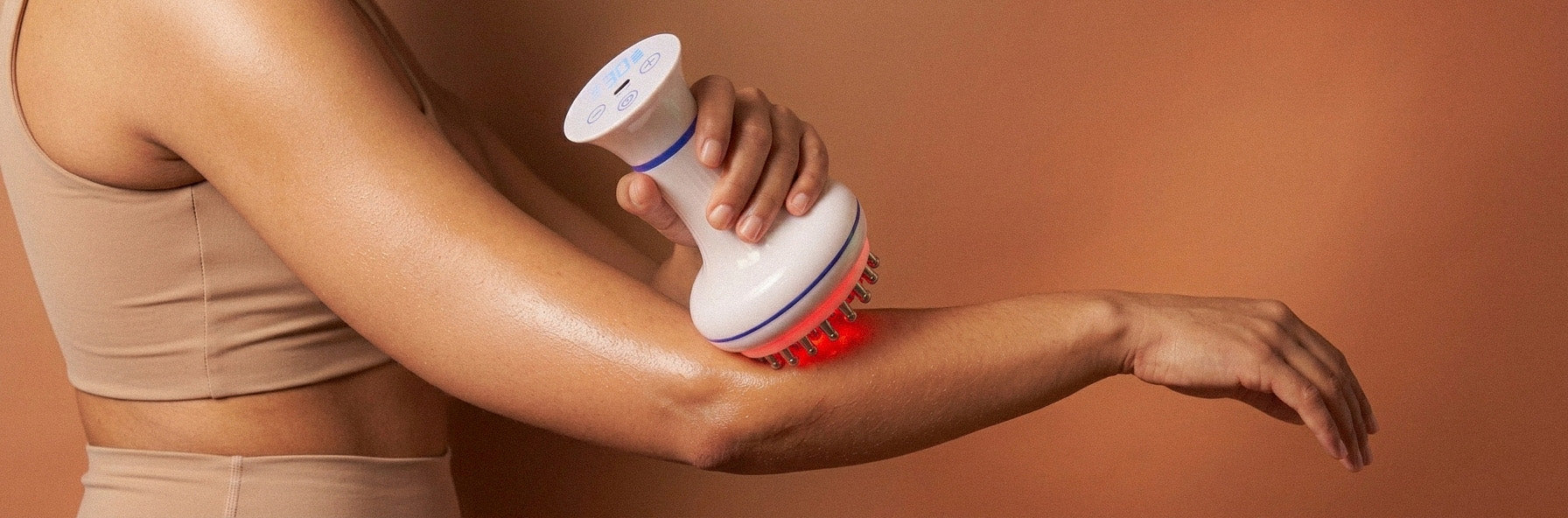 woman using a rollerstone lymphatic drainage massager on her arm during a quiet self-care ritual